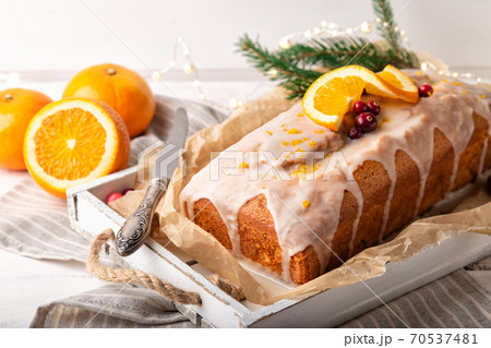 Christmas orange cake with cranberries and sugar icing 70537481