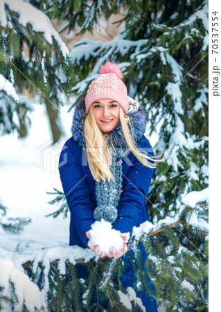 Woman with snow in her hands 70537554