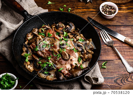 Fried pork neck steak with different mushrooms 70538120