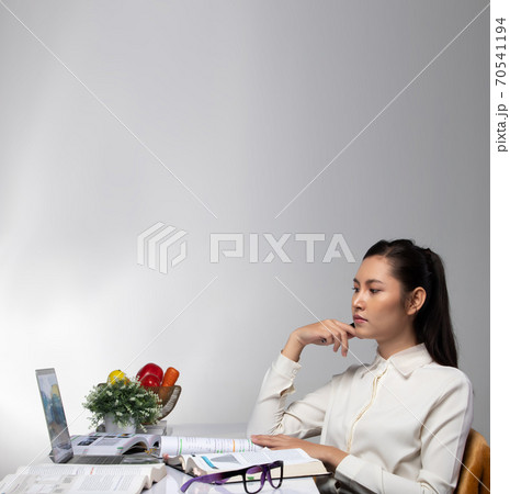 Woman works hard, read books, research notebook and video conference 70541194