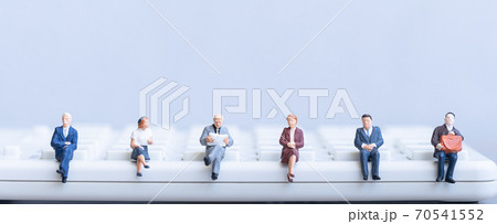 Elderly people sitting on coins stack.  70541552