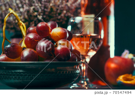 ripe grapes with apple and plums on the background of a glass with wine ripe grapes with apple and plums on the background of a glass with wine 70547494