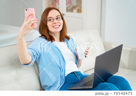 woman doing selfie at work on computer woman doing selfie at work on computer 70548475