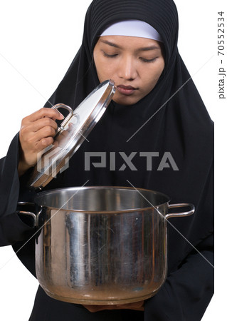 woman carries a large pot woman carries a large pot 70552534