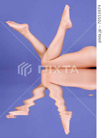 Beautiful legs on blue background Beautiful legs on blue background 70553974