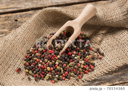 Spices poured on sackcloth, wooden spatula Spices poured on sackcloth, wooden spatula 70554360
