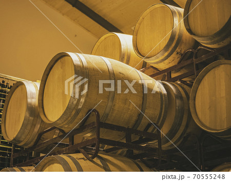 Wine barrels stacked on metal structure in a winery in the Southwest of Spain 70555248
