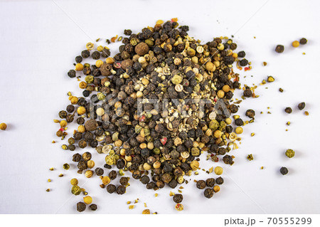 Pile of red, black, spicy, white and sweet peppercorns to season cooking recipes Pile of red, black, spicy, white and sweet peppercorns to season cooking recipes 70555299