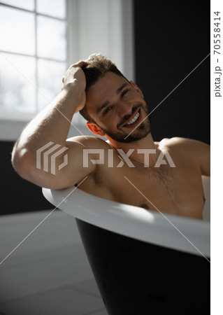 Portrait of man taking bath Portrait of man taking bath 70558414