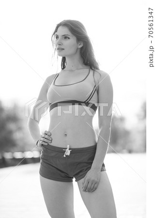 Portrait of a beautiful young sporty brunette girl. Black and white photo. BW Portrait of a beautiful young sporty brunette girl. Black and white photo. BW 70561347
