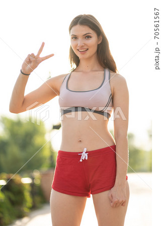 Portrait of a beautiful young sporty brunette girl Portrait of a beautiful young sporty brunette girl 70561567