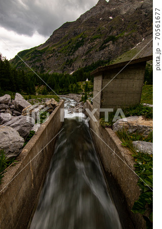 Small waterfalls streaming in green forest in long exposure. water in motion - swiss Alps Small waterfalls streaming in green forest in long exposure. water in motion - swiss Alps 70561677