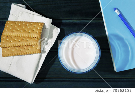 Glass of milk cookies and book 70562155