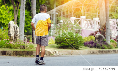 Back view portrait of a Asian elderly man in fitness wear walking and jogging for good health in public park. Senior jogger in nature. Older Man enjoying Peaceful nature. Healthcare concept. Back view portrait of a Asian elderly man in fitness wear walking and jogging for good health in public park. Senior jogger in nature. Older Man enjoying Peaceful nature. Healthcare concept. 70562499