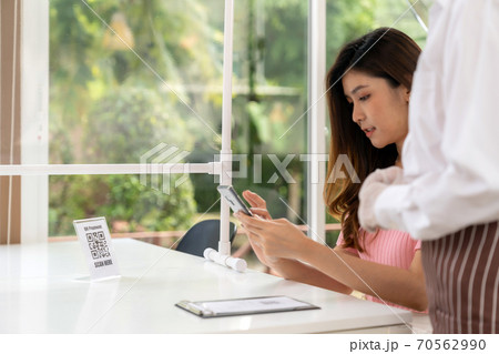 Asian customer scan qr code to make contactless payment Asian customer scan qr code to make contactless payment 70562990