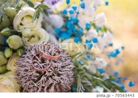 Close up view on wedding rings on rustic brides bouquet Close up view on wedding rings on rustic brides bouquet 70563443