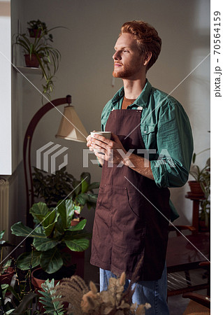 Portrait of florist drinking tasty coffee Portrait of florist drinking tasty coffee 70564159