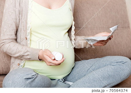 Pregnant Lady Reading Instruction For Prescribed Pills , healthcare concept, medicine during pregnancy 70564374