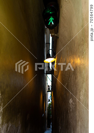 The architecture of the strago city of Prague. The narrowest street in Europe. The passage between buildings for one person, regulated by traffic lights 70564799