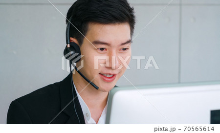 Business people wearing headset working in office 70565614