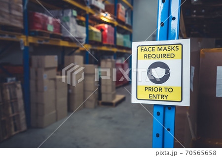 Sign caution in factory warning to industry labor worker to prevent Covid-19 70565658