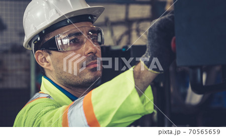 Smart factory worker using machine in factory workshop Smart factory worker using machine in factory workshop 70565659