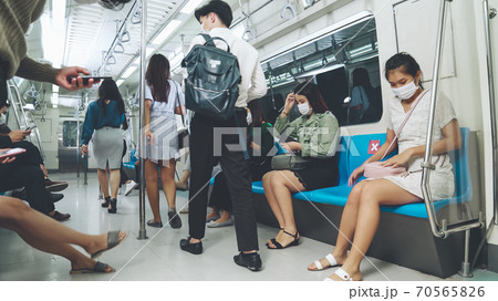 Crowd of people wearing face mask on a crowded public subway train travel Crowd of people wearing face mask on a crowded public subway train travel 70565826