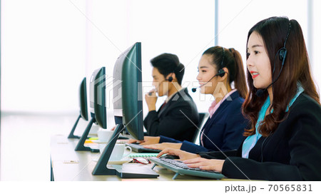 Business people wearing headset working in office Business people wearing headset working in office 70565831