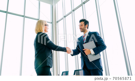 Business people handshake in corporate office 70565871