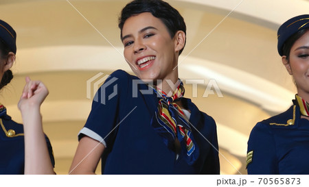 Cabin crew dancing with joy in airplane 70565873