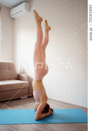 athlete girl is engaged in gymnastics.acrobat home athlete girl is engaged in gymnastics.acrobat home 70565895