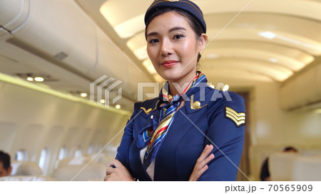 Cabin crew or air hostess working in airplane Cabin crew or air hostess working in airplane 70565909