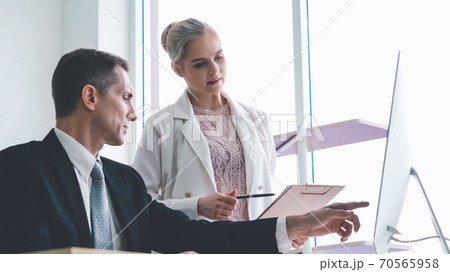 Two business people talk project strategy at office Two business people talk project strategy at office 70565958