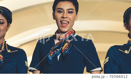 Cabin crew dancing with joy in airplane 70566012