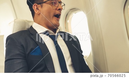 Sleepy businessman travel on a business trip by airplane 70566025