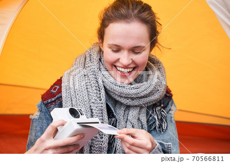 Girl looking with delight at the photo Girl looking with delight at the photo 70566811