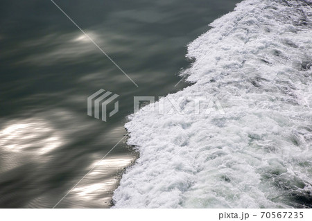 the waves from the ship on the background of the tranquil ocean the waves from the ship on the background of the tranquil ocean 70567235