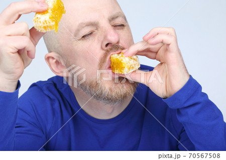 the man is appetizing eats honey 70567508