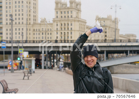 Man does not wearing protective mask outdoors. Coronavirus pandemic time. 70567646