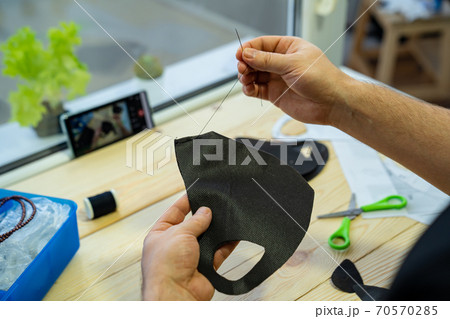 mens hands sew with a needle black facemask mens hands sew with a needle black facemask 70570285