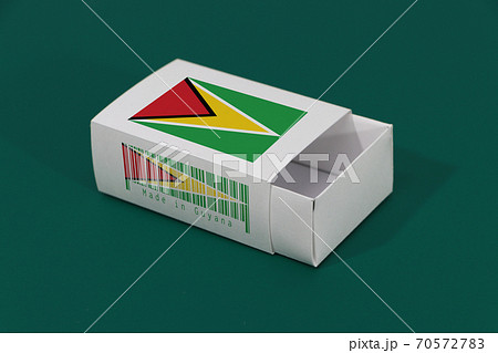 Guyana flag on white box with barcode and the color of nation flag on green background 70572783