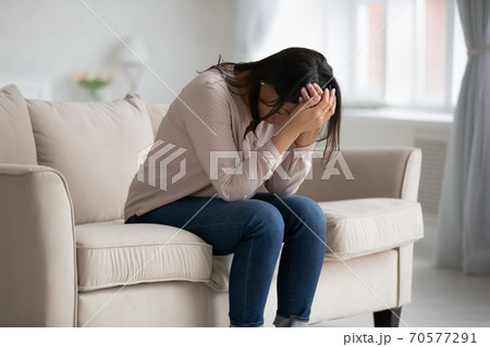 Upset biracial woman suffer from depression at home Upset biracial woman suffer from depression at home 70577291