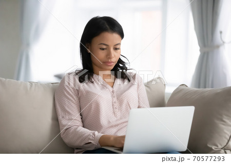 African American woman work on laptop at home 70577293