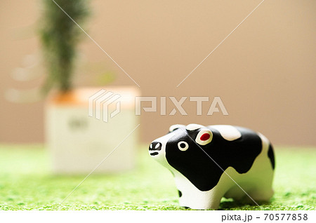 （2021年・丑年）年賀状で使える、草原の中に佇む置物の牛 70577858