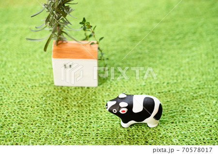 （2021年・丑年）年賀状で使える、草原の中に佇む置物の牛 70578017