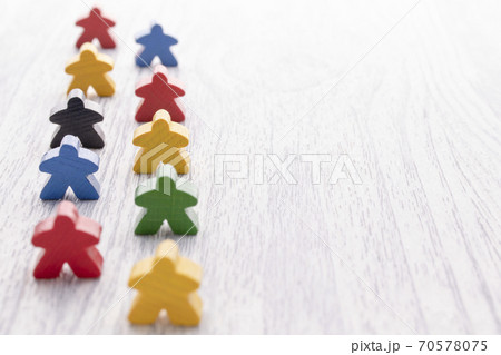 Multicolored wooden figures in the form of stars. Parts of the board game. Leadership skills. copy space 70578075