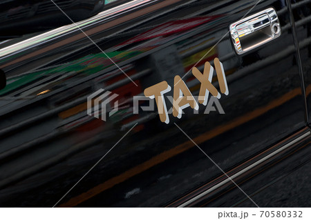 Taxi sign on the door of a taxi car in the streets. Taxi sign on the door of a taxi car in the streets. 70580332