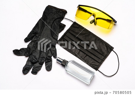 Safety equipment to fight to Coronavirus COVID-19 virus outbreak - Safety mask, hand sanitizer, latex gloves and protective glasses or goggles 70580505