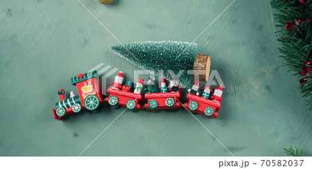 Christmas festive green background with toy train Christmas festive green background with toy train 70582037