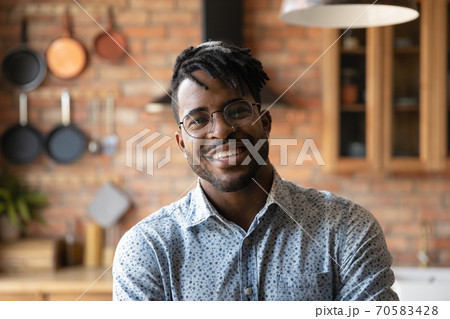 Headshot portrait of smiling African American man in glasses Headshot portrait of smiling African American man in glasses 70583428